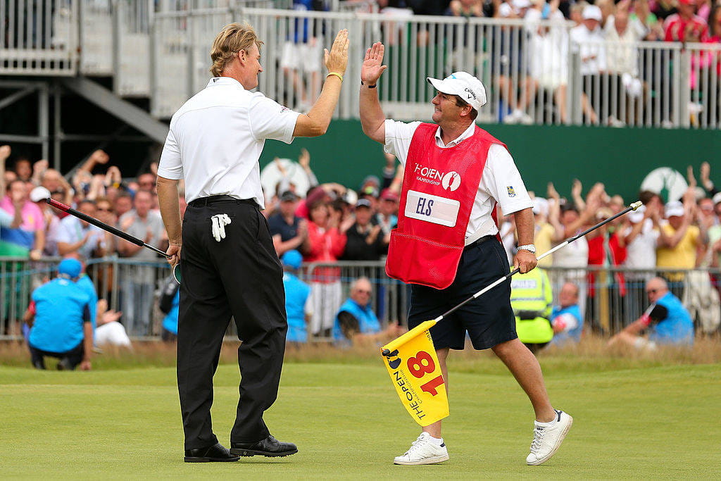 Ernie Els is congratulated by his caddie, Ricci Roberts, after his final putt in The 141st Open